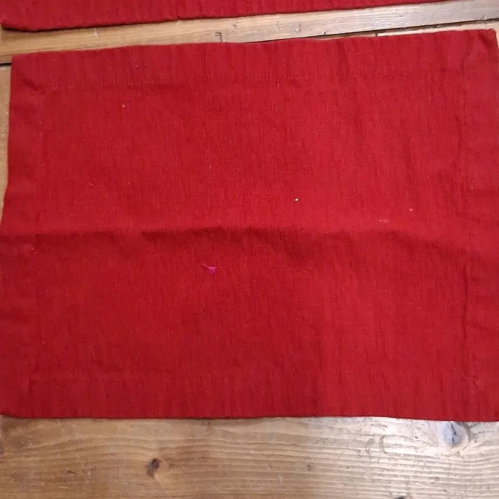 Set of 7‎ red corduroy placemats.